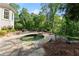 Secluded hot tub surrounded by trees and stone patio at 2960 Millwater Xing, Dacula, GA 30019
