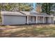 Newly painted gray house with white trim and a covered porch at 9220 Bayou Ln, Jonesboro, GA 30238