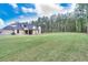 Expansive backyard with lush green grass and privacy provided by mature trees at 2106 Lacroix Way, Conyers, GA 30094