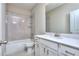 A well-lit bathroom featuring a tiled shower-tub, vanity, and toilet at 2106 Lacroix Way, Conyers, GA 30094