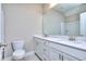 Bathroom with double vanity, white cabinets, modern faucets, a toilet, and a shower at 2106 Lacroix Way, Conyers, GA 30094