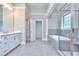 A luxurious bathroom featuring dual sinks, a soaking tub, and a glass-enclosed shower at 2106 Lacroix Way, Conyers, GA 30094