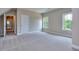 Large bedroom featuring neutral walls, carpeting, trim, natural light, and nearby hallway entrance at 2106 Lacroix Way, Conyers, GA 30094
