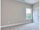 Bright bedroom features neutral carpet, a large window, and a convenient adjacent door at 2106 Lacroix Way, Conyers, GA 30094