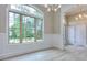 Bright dining room with large windows, decorative chandelier, and stylish trim work at 2106 Lacroix Way, Conyers, GA 30094