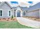 Charming brick home with a walkway leading to a covered entrance and professionally landscaped flowerbeds at 2106 Lacroix Way, Conyers, GA 30094