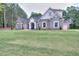 Beautiful two-story brick home with an arched entryway and manicured front lawn at 2106 Lacroix Way, Conyers, GA 30094