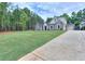 Stately two-story brick home featuring a manicured lawn, side entry garage and mature trees at 2106 Lacroix Way, Conyers, GA 30094