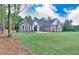 Well-maintained two-story home with a brick exterior and an expansive, green front yard at 2106 Lacroix Way, Conyers, GA 30094