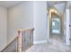 Bright hallway with neutral paint, plush carpeting, and decorative iron railing on the staircase at 2106 Lacroix Way, Conyers, GA 30094