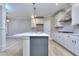 Island sink in a bright kitchen features white cabinets, stainless steel appliances, and an island at 2106 Lacroix Way, Conyers, GA 30094
