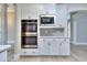 Built-in stainless steel oven and microwave nestled in white cabinetry with herringbone backsplash at 2106 Lacroix Way, Conyers, GA 30094