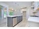 Spacious kitchen boasts white cabinets, stainless steel appliances, and a gray kitchen island at 2106 Lacroix Way, Conyers, GA 30094