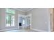 Bright living area with large windows and elegant archways, offering an open view into other living spaces at 2106 Lacroix Way, Conyers, GA 30094