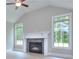Bright living room with a fireplace, large windows, and hardwood floors at 2106 Lacroix Way, Conyers, GA 30094