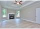 Large living room features a fireplace, light wood floors, white trim, and large windows at 2106 Lacroix Way, Conyers, GA 30094