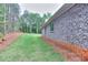 Exterior view showcasing brick siding and a well-maintained lawn at 2106 Lacroix Way, Conyers, GA 30094