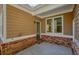 Covered back patio featuring a brick base and access to a window and back door entrance at 3606 High Battery Nw Blf, Acworth, GA 30101