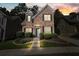 Charming brick home with manicured lawn, black shutters, and a welcoming entrance with landscape lighting at 3606 High Battery Nw Blf, Acworth, GA 30101