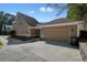 Tan colored garage with driveway and landscaping at 3606 High Battery Nw Blf, Acworth, GA 30101