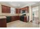 Spacious kitchen boasts warm-toned cabinetry, black appliances, and easy access to the home's interior at 3606 High Battery Nw Blf, Acworth, GA 30101