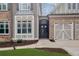 Ornate front door and walkway leading to a three-car garage at 2733 Caldwell Rd, Brookhaven, GA 30319