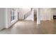 Light-filled living room with hardwood floors and staircase at 2733 Caldwell Rd, Brookhaven, GA 30319