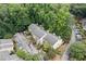 Aerial view of a multifamily residential dwelling surrounded by mature trees and ample parking at 2927 Torreya Se Way, Marietta, GA 30067