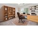 Comfortable office space features custom shelves, built-in desk, and rolling chair at 2927 Torreya Se Way, Marietta, GA 30067