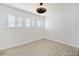 Bright room featuring three windows with blinds, neutral walls, and modern ceiling fan at 2927 Torreya Se Way, Marietta, GA 30067