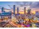 Aerial view of the Atlanta cityscape at sunset, highlighting prominent buildings and attractions at 3268 Lions Ruby Ln, Atlanta, GA 30349