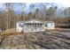 White manufactured home with gray metal roof, front porch, and landscaping at 4196 Bryan Dr, Acworth, GA 30102