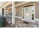 Inviting front entrance featuring a stone porch, decorative glass door, and a welcoming 'Let's Stay Home' doormat at 2182 Nillville Dr, Buford, GA 30519