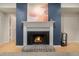 Fireplace with white mantel and blue accent wall at 918 Cannongate Sw Xing, Marietta, GA 30064