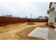 A large backyard features a wood fence, some landscaping, and a concrete patio at 3004 Amabile Rd, Dacula, GA 30019