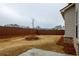 Backyard featuring a wooden fence, sparse landscaping, and a small patio at 3004 Amabile Rd, Dacula, GA 30019