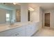 Bathroom with dual sinks, white cabinetry, quartz countertops, and tile flooring at 3004 Amabile Rd, Dacula, GA 30019