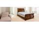Bedroom featuring a cozy seating area, plush carpeting and ornate dark wood bed frame at 3004 Amabile Rd, Dacula, GA 30019