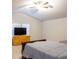 Vaulted ceiling bedroom with ceiling fan, dresser, and a comfortable bed with a gray comforter at 3004 Amabile Rd, Dacula, GA 30019