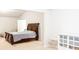 Bedroom featuring a dark wood sleigh bed, neutral carpet, and lounge chair at 3004 Amabile Rd, Dacula, GA 30019