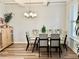 Dining room with hardwood floors, chandelier, and glass dining table at 3004 Amabile Rd, Dacula, GA 30019