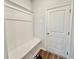 White bench with storage in an entryway with wood floors at 3004 Amabile Rd, Dacula, GA 30019