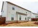 View of the side of the home featuring neutral siding, brick, and green space at 3004 Amabile Rd, Dacula, GA 30019