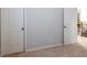 Hallway with a view of the wood and iron banister staircase and two doors at 3004 Amabile Rd, Dacula, GA 30019