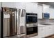 Kitchen with stainless steel refrigerator, oven, microwave, and white cabinets at 3004 Amabile Rd, Dacula, GA 30019