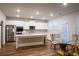 Open kitchen featuring hardwood floors, a large island, stainless appliances, and plenty of light at 3004 Amabile Rd, Dacula, GA 30019