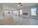 Open-concept living room featuring hardwood floors, fireplace, and view into the kitchen at 3004 Amabile Rd, Dacula, GA 30019