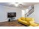 Living room features hardwood floors and stairway with wood and iron handrail at 3004 Amabile Rd, Dacula, GA 30019