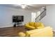 Living room features hardwood floors and stairway with wood and iron handrail at 3004 Amabile Rd, Dacula, GA 30019