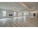 Open-concept living room featuring hardwood floors, fireplace, and view into the kitchen at 3004 Amabile Rd, Dacula, GA 30019